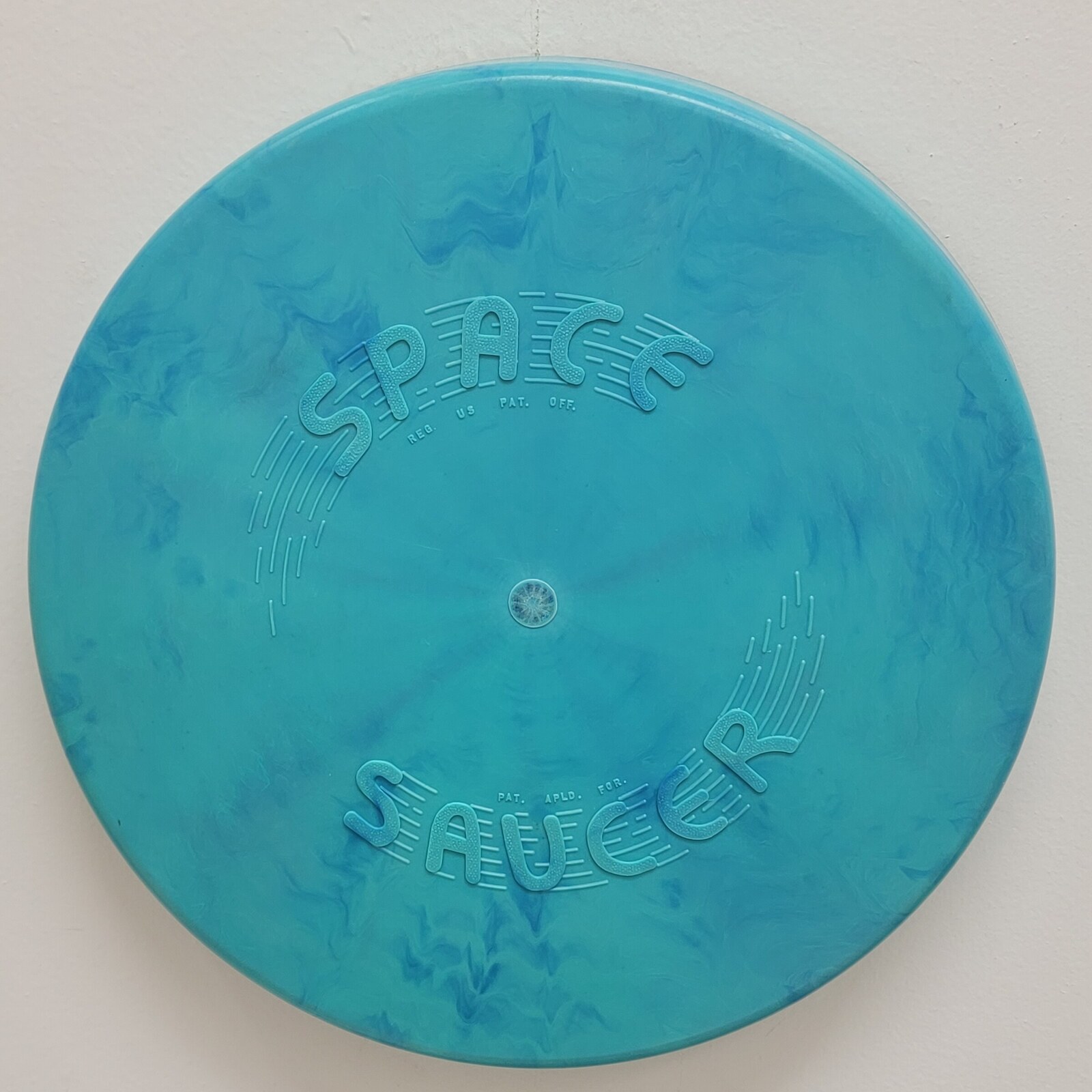 Front of the turquoise 1957 Space Saucer flying disc.