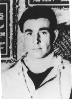 Black-and-white portrait of a young Ernest C. Bill Robes wearing a light-colored jacket.