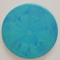 Front of the turquoise 1957 Space Saucer flying disc.